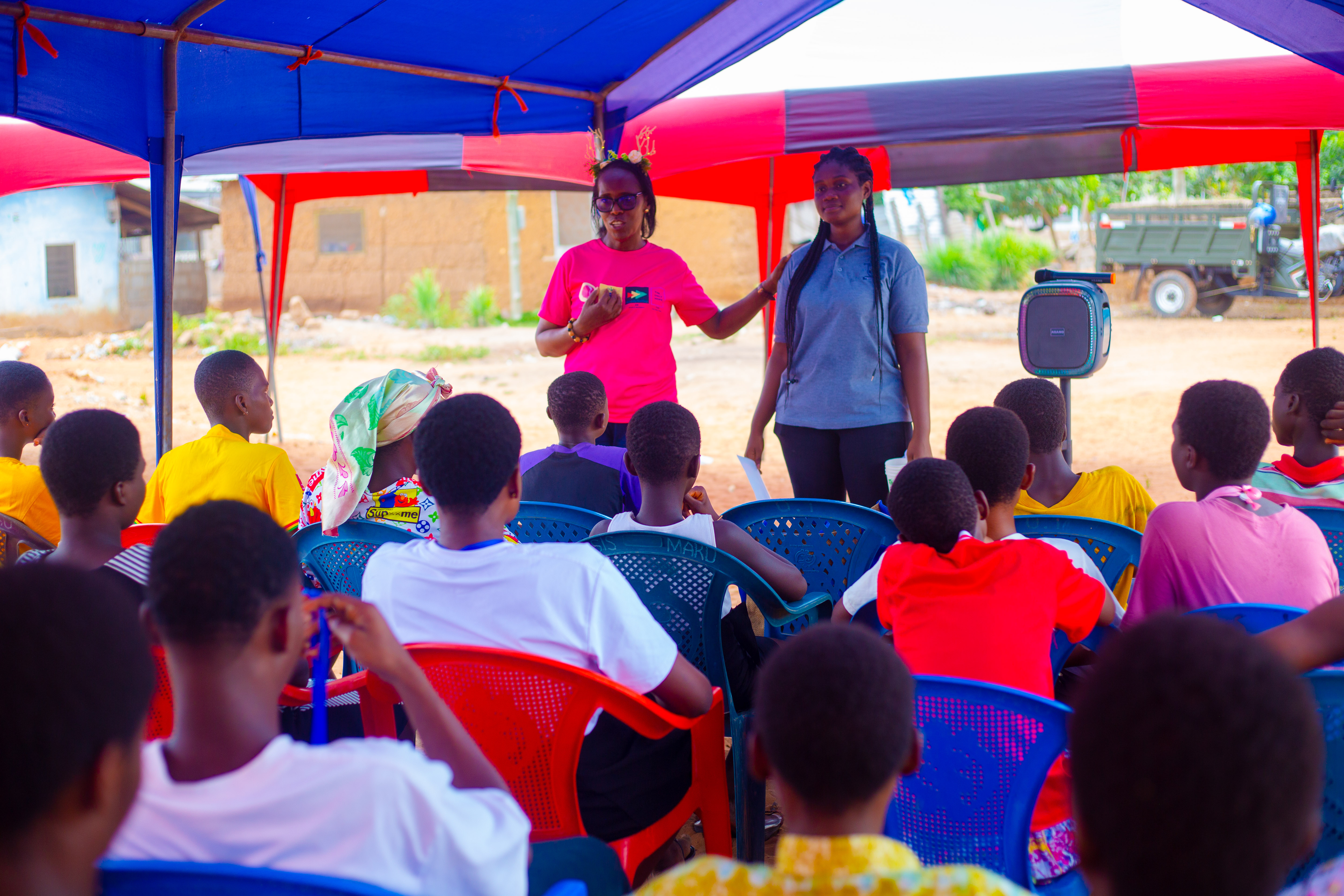 The SAYS team sharing a message with community members