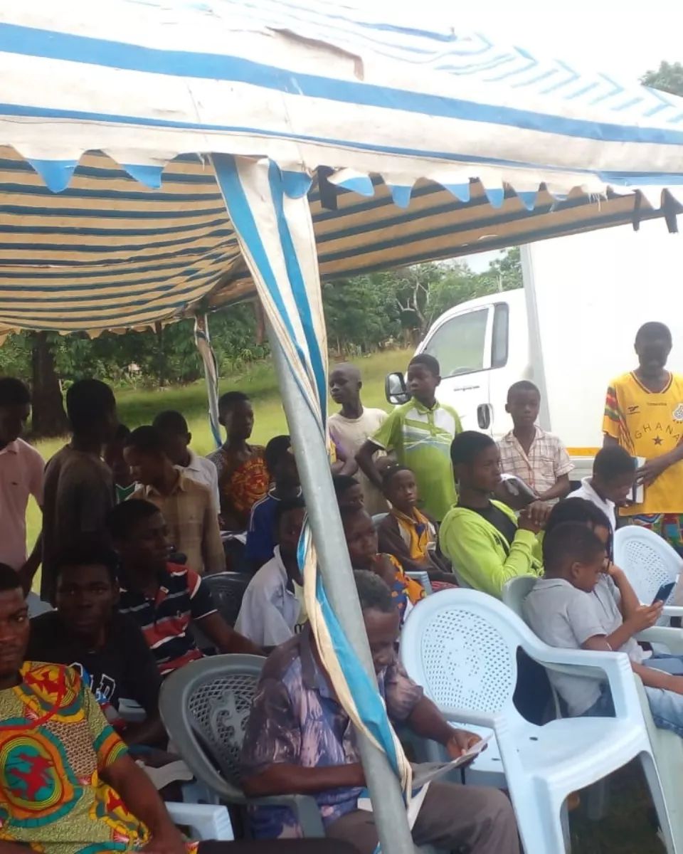Community members seated during preaching of the Gosple